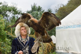 Professional trainer holding Golden Eagle with spread wings at Sunkar Raptor Center Almaty Kazakhstan