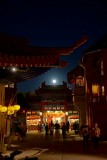 Moon rising through China streets