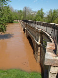 Muddy water under the aqueduct