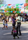 Kids play while the adults dance