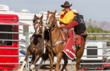 After completing his ride the rider transfers to safety on another horse