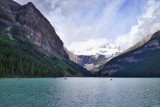 Lake Louise is dwarfed by five massive mountains