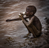 Dassanech Child Drinking from the Omo River
