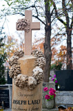 An Old Tombstone With Grapes