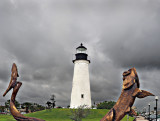 Wooden tarpon sculpture and lighthouse