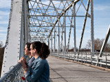 Grand daughter and daughter enjoying the view of the Colorado River from bridge, Bastrop, TX