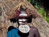 Surma woman with lip plate and decoration;  south-western Ethiopia.