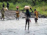 Surma people crossing the Kibish River; south-western Ethiopia.
