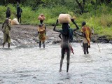 Surma people crossing the Kibish River;  south-western Ethiopia.