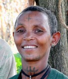 Amharic woman in Yebab near Bahirdar with tattoos. The cross on her forehead shows that she is a Christian. Ethiopia