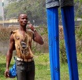 « Festival des 18 Montagnes de Man », Côte d’Ivoire. Partner of the dancer on stilts with protective amulets.