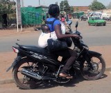 Mother and her baby on a motorbike, Burkina Faso