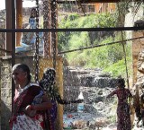 Devotees collecting holy water and taking a shower at Yellamma temple, Saundatti, Karnataka, India