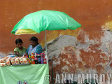 Vendor with green umbrella
