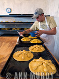 Applying glaze to hojaldras bread<meta name=pinterest content=nopin />