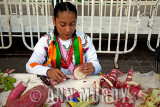 Little girl working on her radish carvings<meta name=pinterest content=nopin />