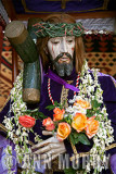 Cristo holding yellow roses