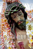 Cristo covered with leis of flor de mayo