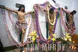 Cristos draped with leis of flowers