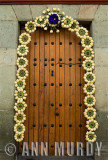 Doorway decorated with hearts of palm coronas