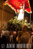 Priest carrying processional float