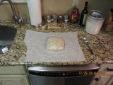 Defrost dough in refrigerator and then bring to room temperature at least an hour before forming the pizza.