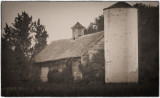 An Old Barn With a Concrete Silo