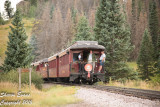 Train 215 is over the summit as several passengers talk to the conductor