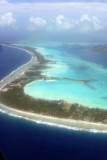 The deep blue sea surrounds the turquoise lagoon of Bora Bora