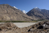 Looking across a wide sandy section of the Panj River to several Afghan peaks including Kohe Kesni Khan