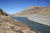 Wide section of the Panj River with sandy flats on the Afghanistan side