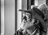 Man in hat on ferry in mono 