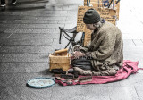 Homeless shoe shine man in street