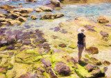 Woman in hat on rockshelf 