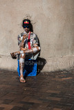 Aboriginal street performer on his smart phone