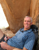 Brian beside the sheep in the shade