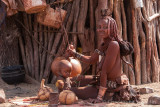 Himba woman preparing curd