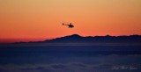 R44 above fog at sunset Seattle