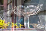 An antique vase through the window reflections.