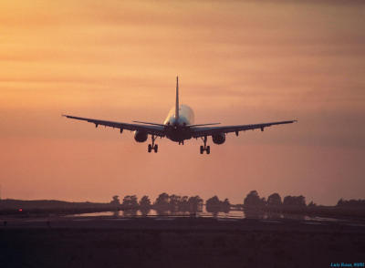 A320 landing at sunset