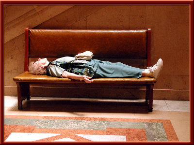 What a relief it was when she opened her eyes to tell us she was fine! Lady resting on bench at museum