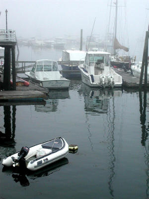 In the early morning boats are surrounded by fog