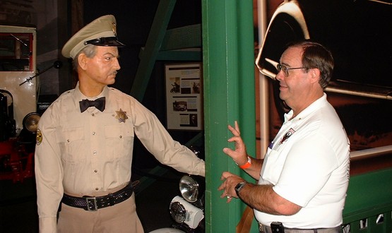 6-A motorcycle officer in the Museum confronts our leader Larry.