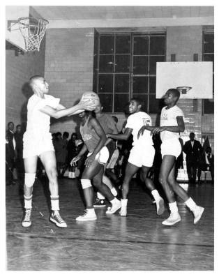 During a scrimmage with this Uptown Team (circa 1963), Henry Pedrozo was getting ready to throw one of his Globetrotter passes to me between Boo Davis, Bugsby. From the look on my face, I was trying to figure out how I was going to catch this pass, and then, what to do with it. 
