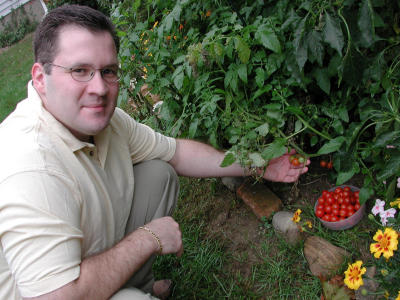 Jim shows off his tomato plant