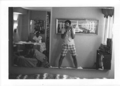 Great shot shooting into a mirror while life went on in the apartment. Don't miss the reel-to-reel recorder on the right.