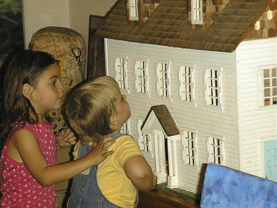 Girls Checking Out The Haunted Dollhouse