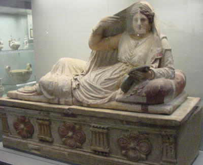 A painted terra cotta sarcophagus of Seianti Hanunia Tiesnasa includes a replica of her on its cover. (Etruscan 150-130 B.C.)