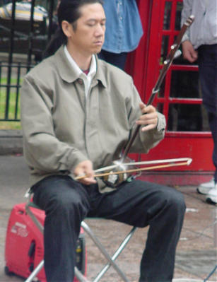 Leicester Square(pronounced Lester) is a fascinating place.  It is in the heart of the theatre district (not movie theatres!). It attracts many people, and on the day I was there one of the people was David Li.