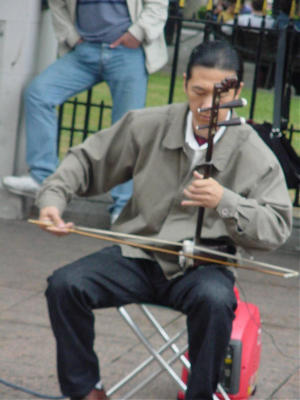 David is playing the Erhu Chinese Fiddle.  I only know this because I bought his CD. (grin)  If you are in my 7th grade class, you will learn to love it or else...